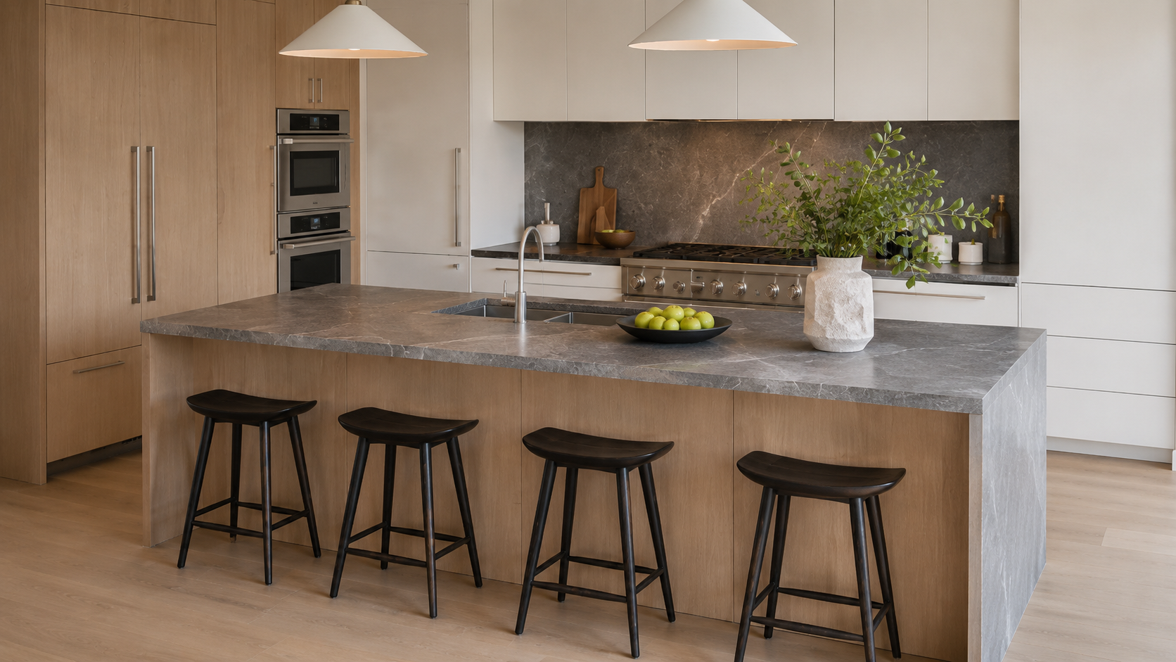 Built-in refrigerator and oven surrounded by custom appliance cabinets
